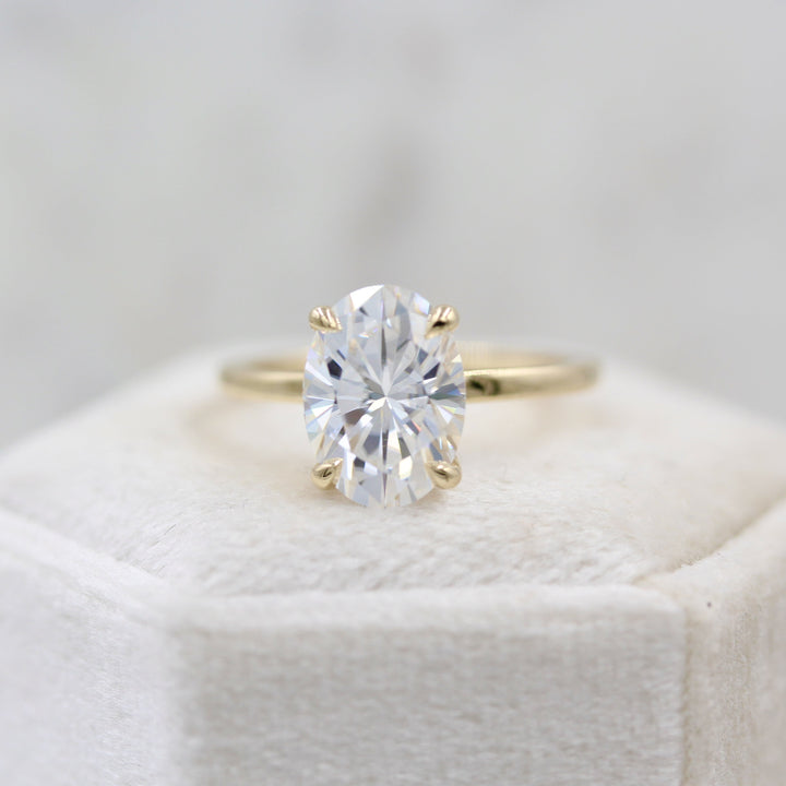 Oval solitaire engagement ring with dainty claw prongs
