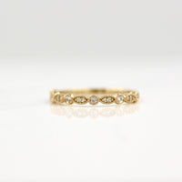 Yellow gold vintage-style wedding band with lab-grown diamonds and milgrain details