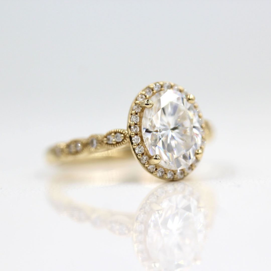 Yellow gold engagement ring with 2ct oval moissanite center and vintage-inspired details 