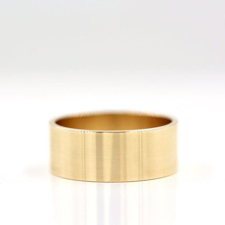 8mm Gold Cigar Band Wedding Ring on white background