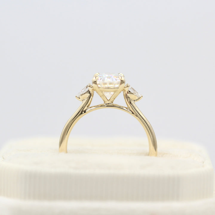 Profile view of 2ct oval moissanite engagement ring with pear accents