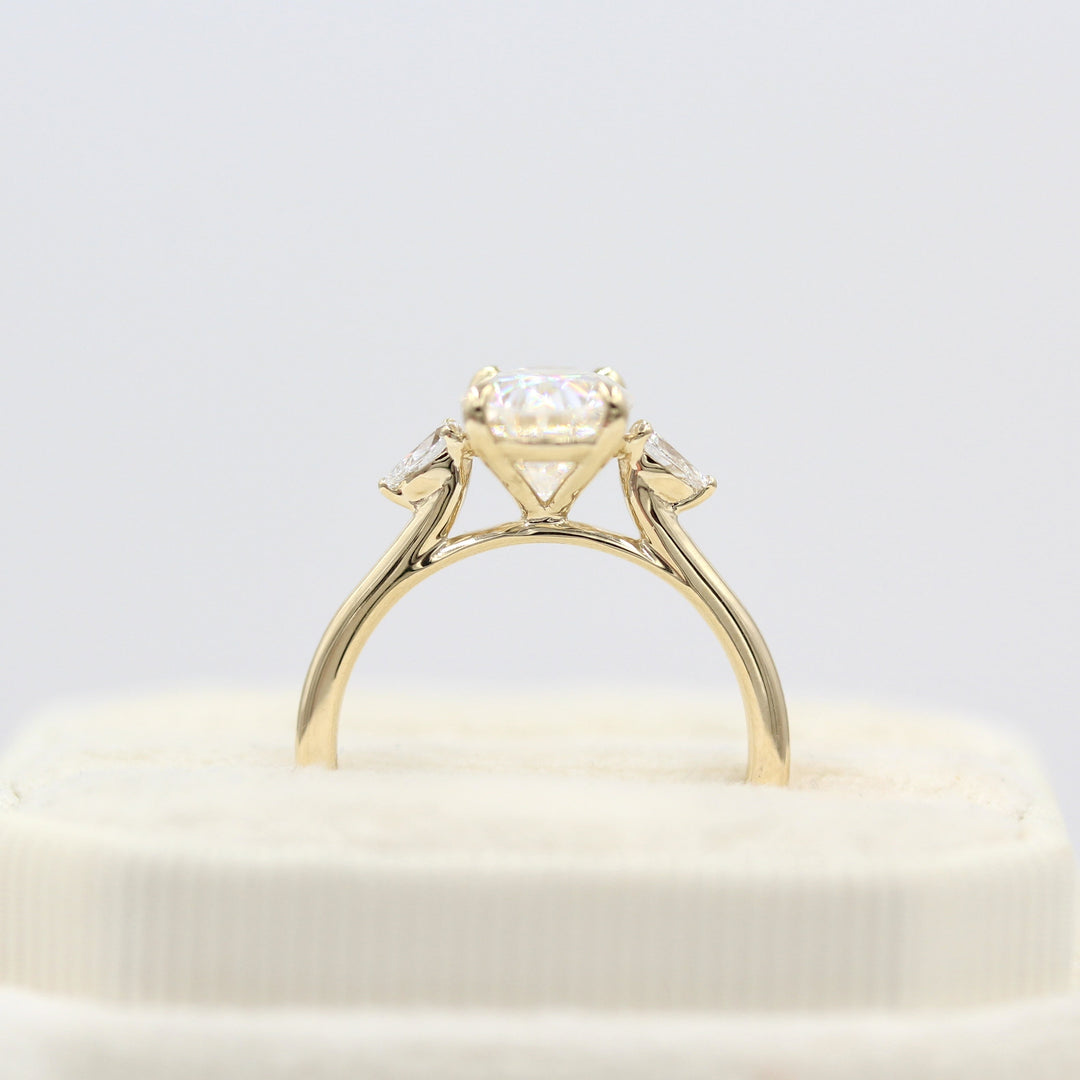 Profile view of 2ct oval moissanite engagement ring with pear accents