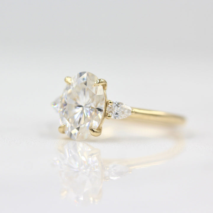 2ct oval moissanite engagement ring with pear accents slightly angled