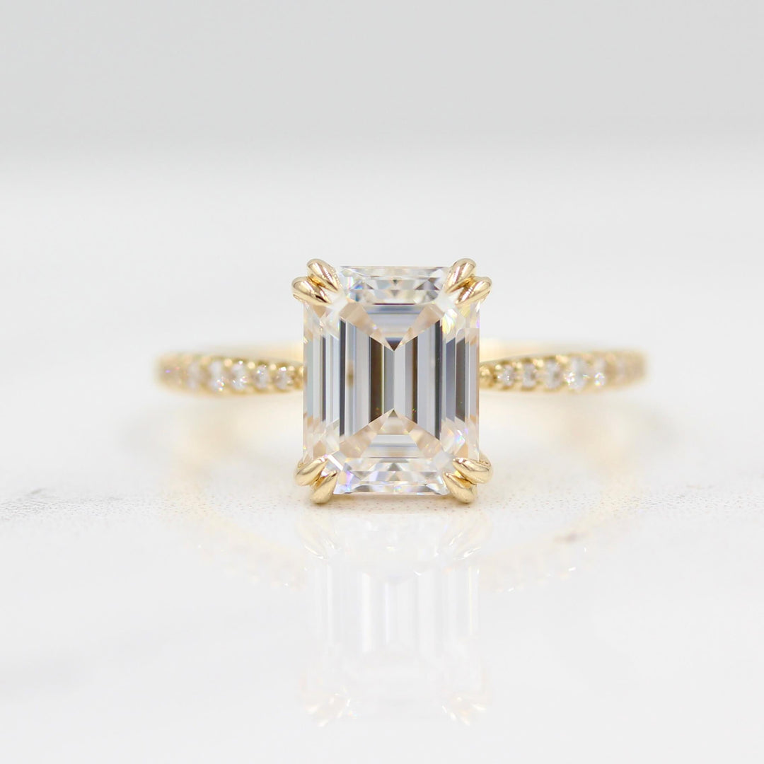 Emerald-cut moissanite engagement ring with pavé band