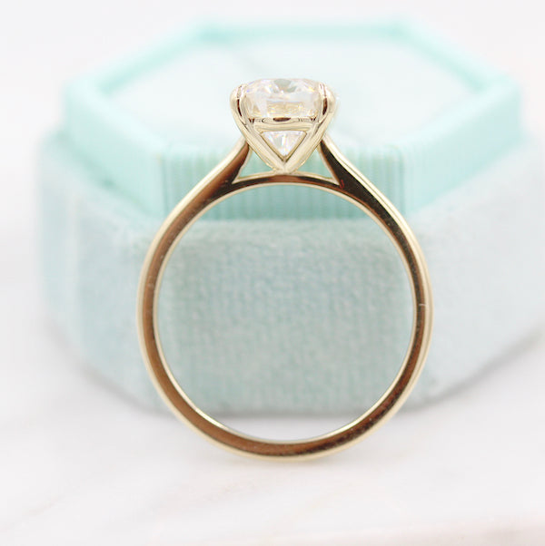 close up of the Maya oval solitaire diamond engagement ring with teal box