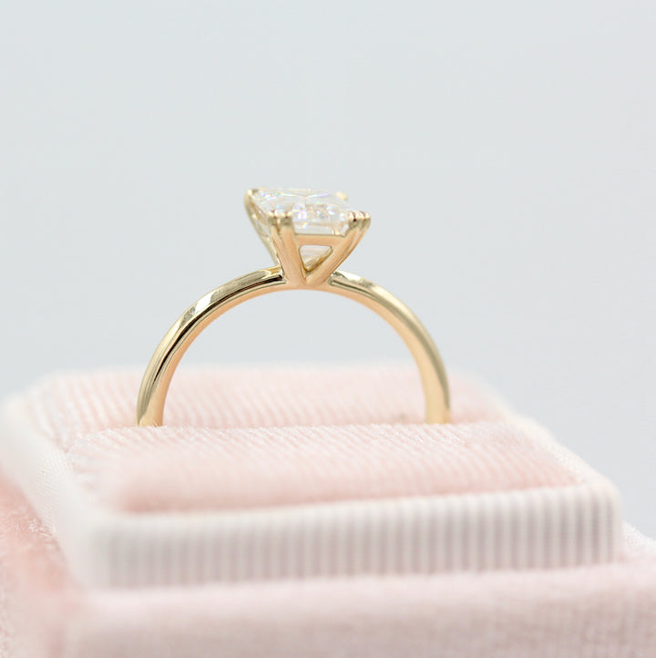 The Serena Ring (Emerald) in yellow gold in a pink velvet ring box