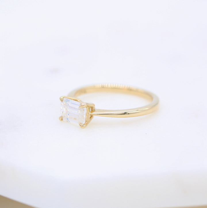 Side shot of yellow gold solitaire ring showing off pinched band