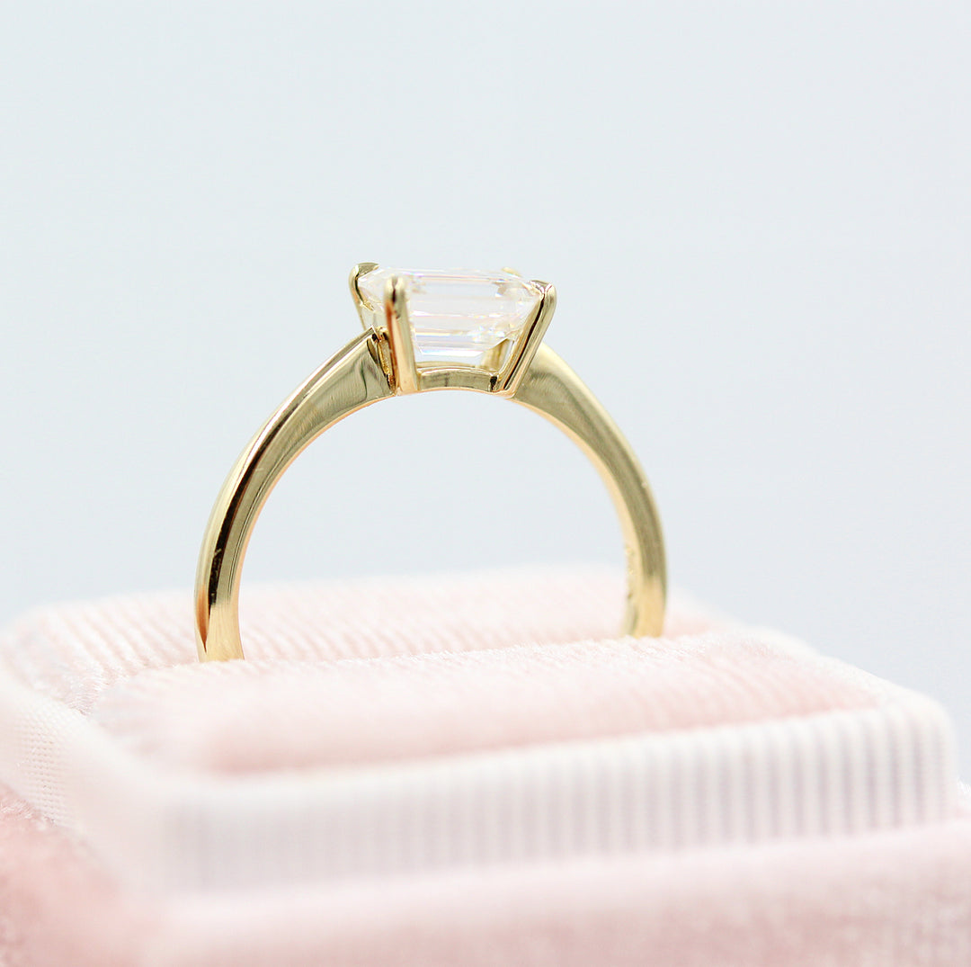Yellow gold solitaire in a light pink ring box