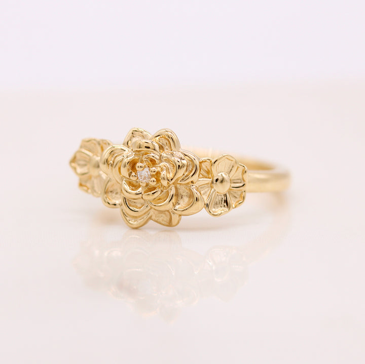 The Posy ring in yellow gold against a white background