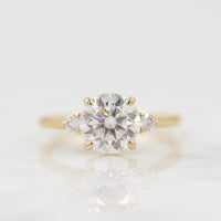The Esme Ring (Round) in Yellow Gold with 2ct Moissanite against a white background