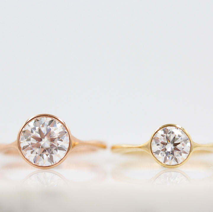 Two Stevie round bezel engagement rings--2ct rose gold ring and 1ct yellow gold ring