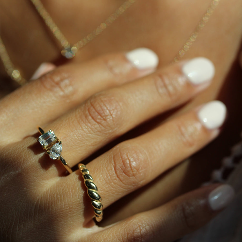 Model wearing petite toi et moi ring and petite croissant ring in natural sunlight