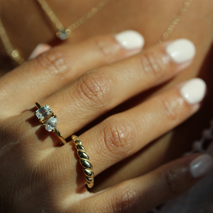 Model wearing petite croissant ring with petite toi et moi ring