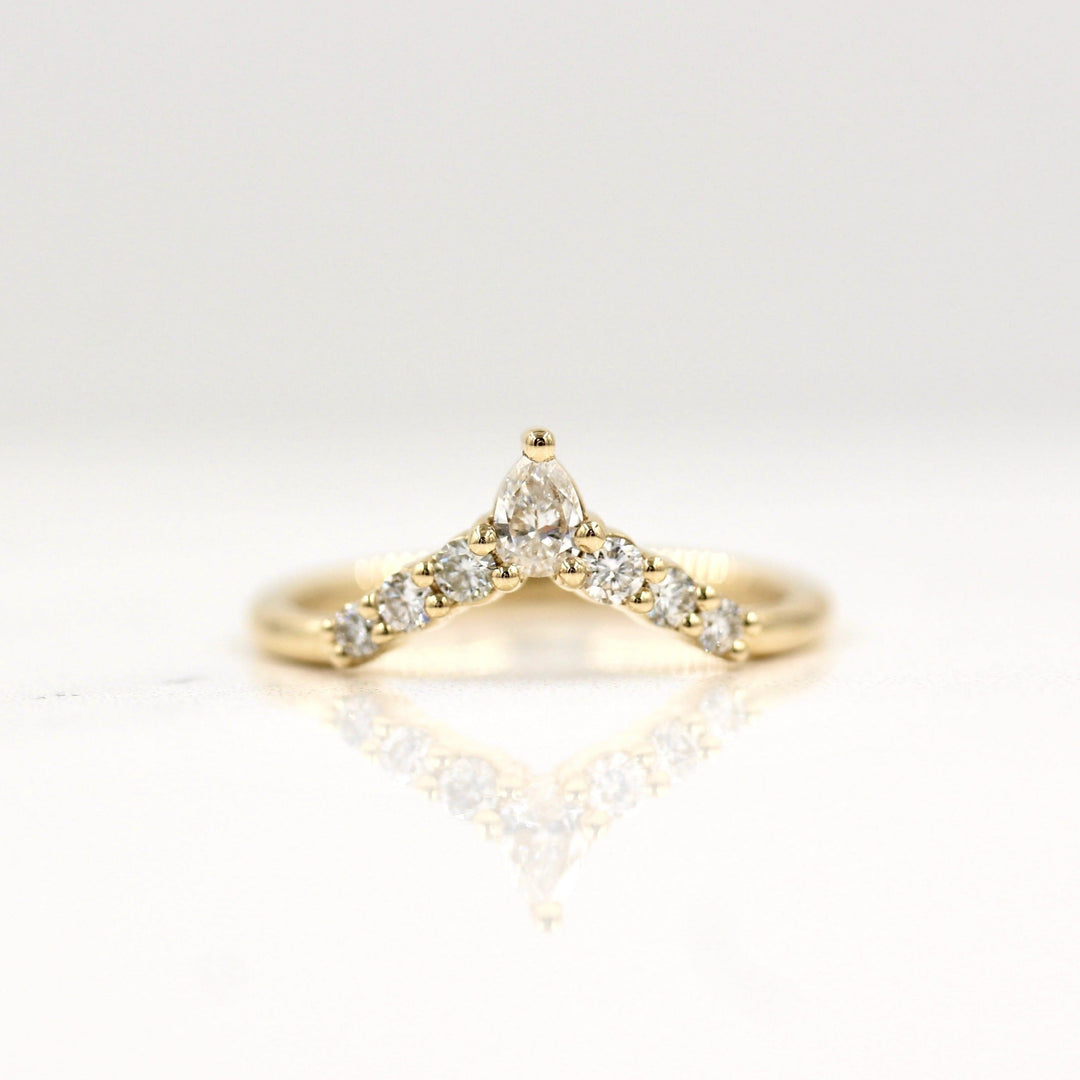 Lab-grown diamond contour wedding band in yellow gold with six rounds and a pear diamond at the top