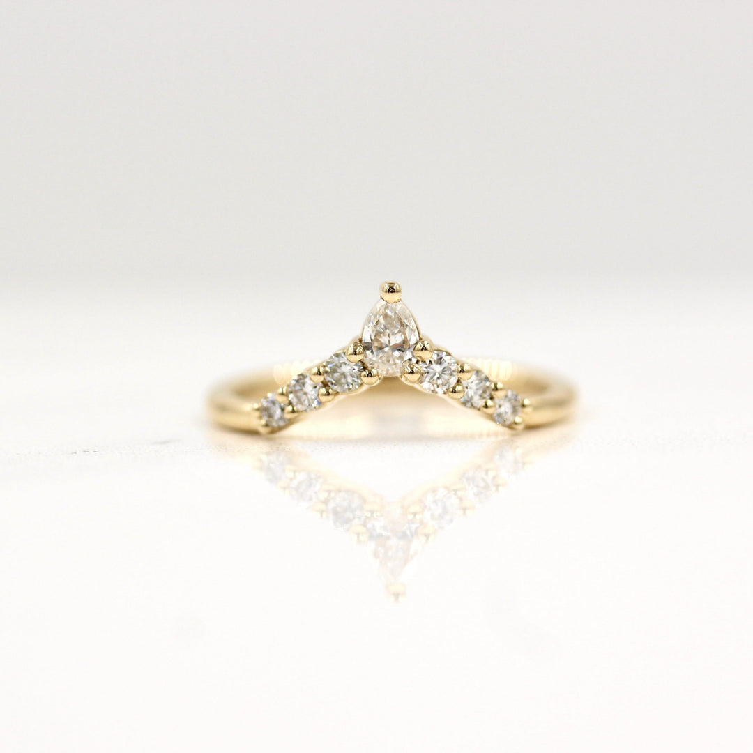Lab-grown diamond contour wedding band in yellow gold with six rounds and a pear diamond at the top