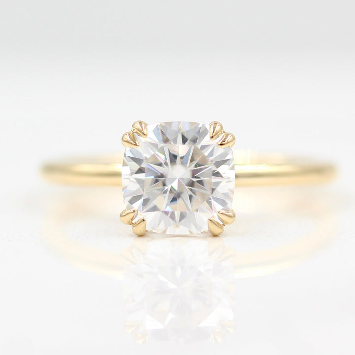 Cushion solitaire engagement ring with double claw prongs in 14k yellow gold