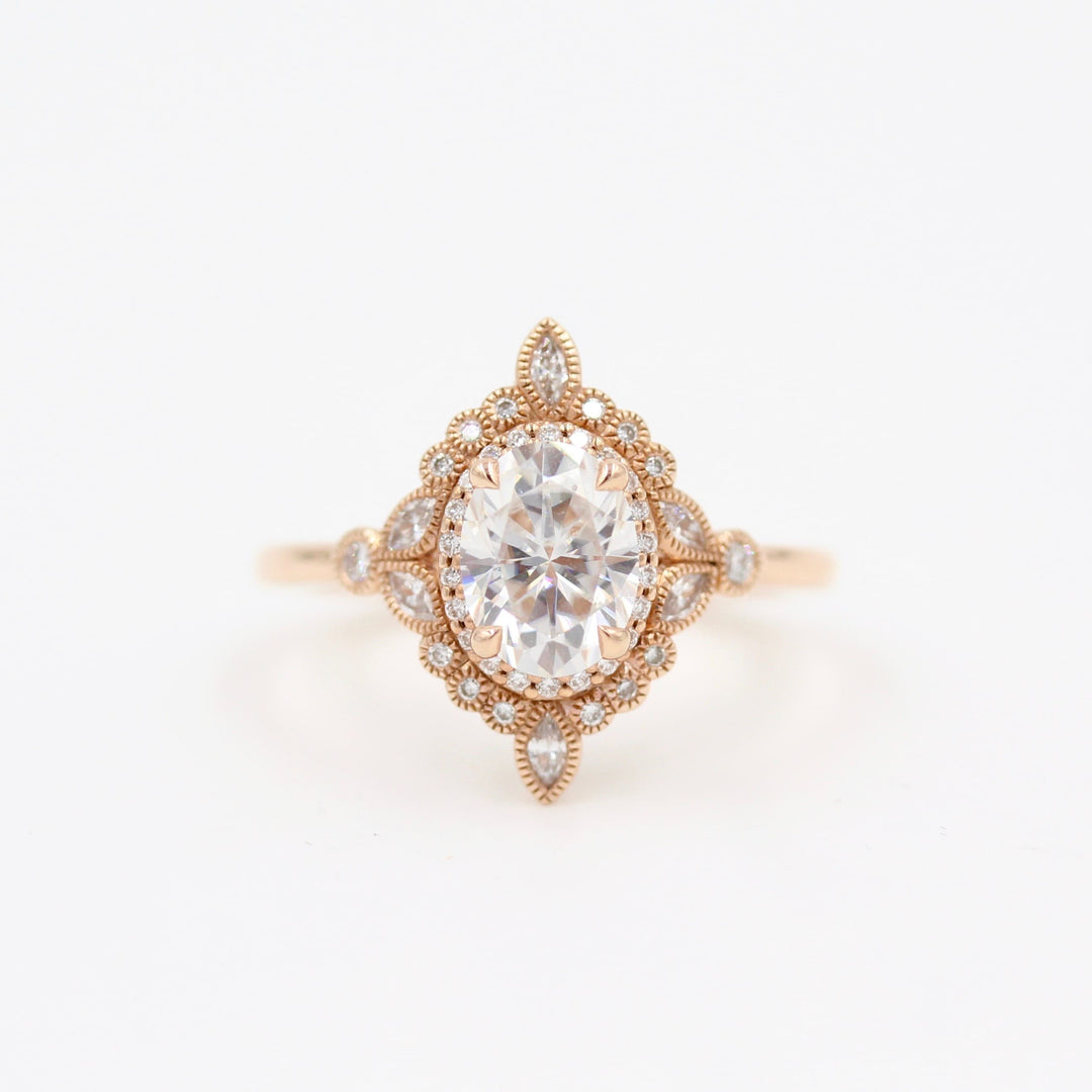 Intricate vintage-style halo engagement ring with milgrain details in rose gold