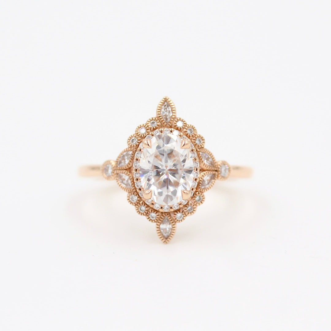 Intricate vintage-style halo engagement ring with milgrain details in rose gold