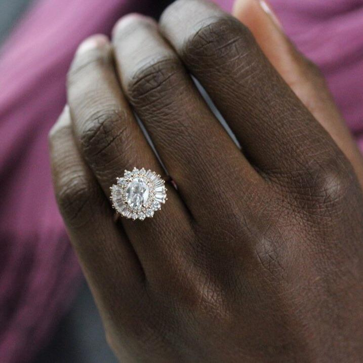 The Soleil Ring in Rose Gold and Moissanite modeled on a hand