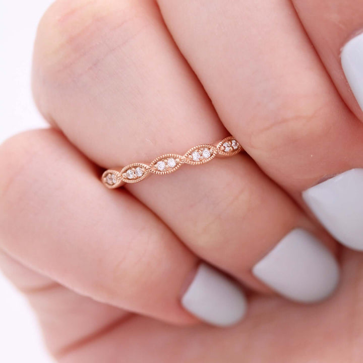 a model wearing a rose gold scalloped wedding band