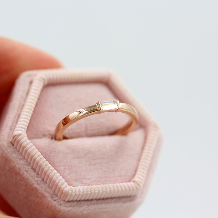 a rose gold baguette ring in a ring box