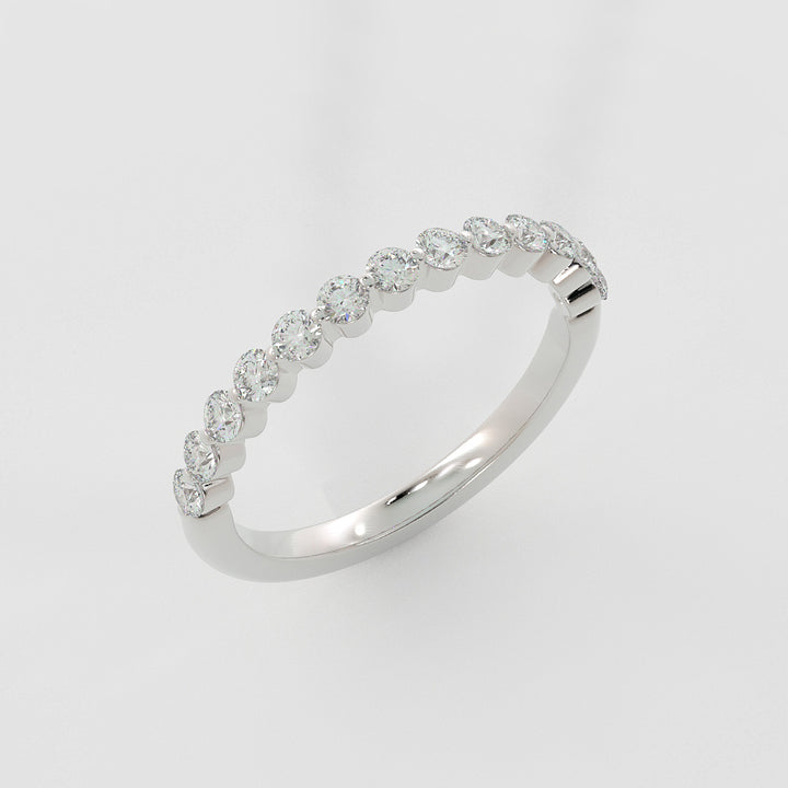 a white gold diamond ring standing up on a white surface