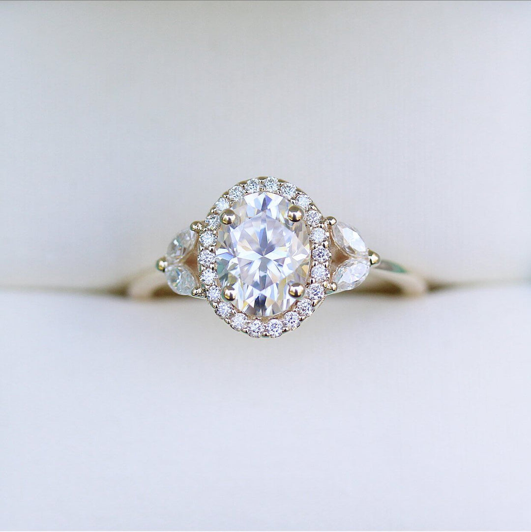 a yellow gold oval diamond engagement ring.