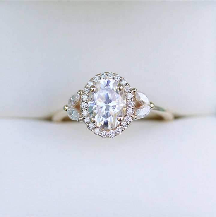 a yellow gold oval diamond engagement ring.